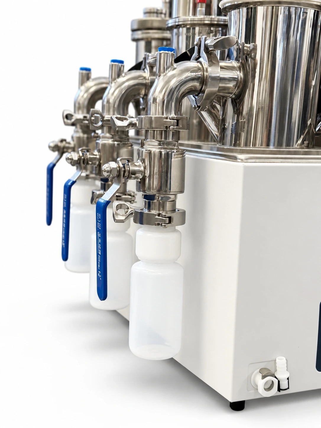 Close-up of the Phoenix stainless steel reactors, feeding ports and effluent bottles